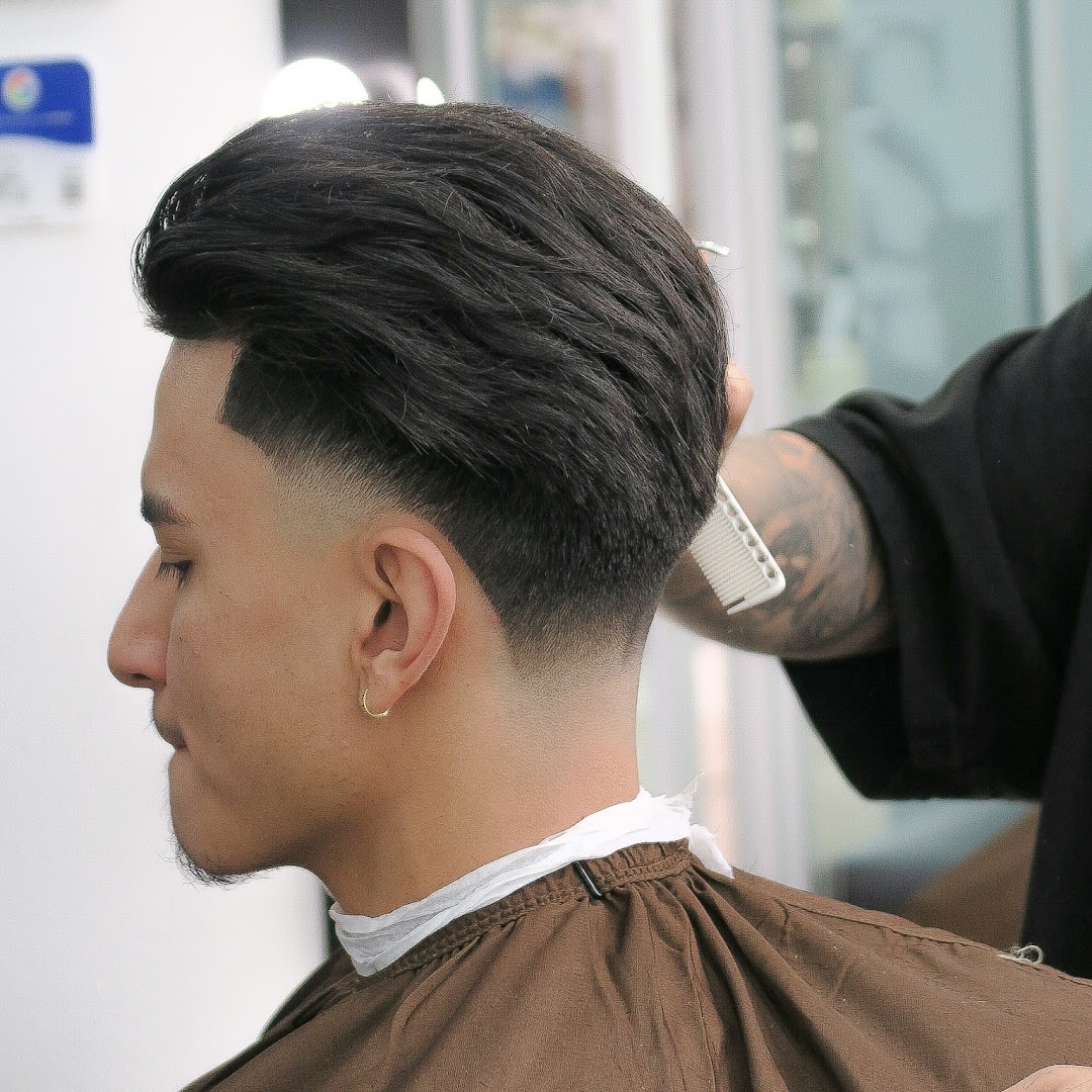 Finished side-profile, mid-taper fade.