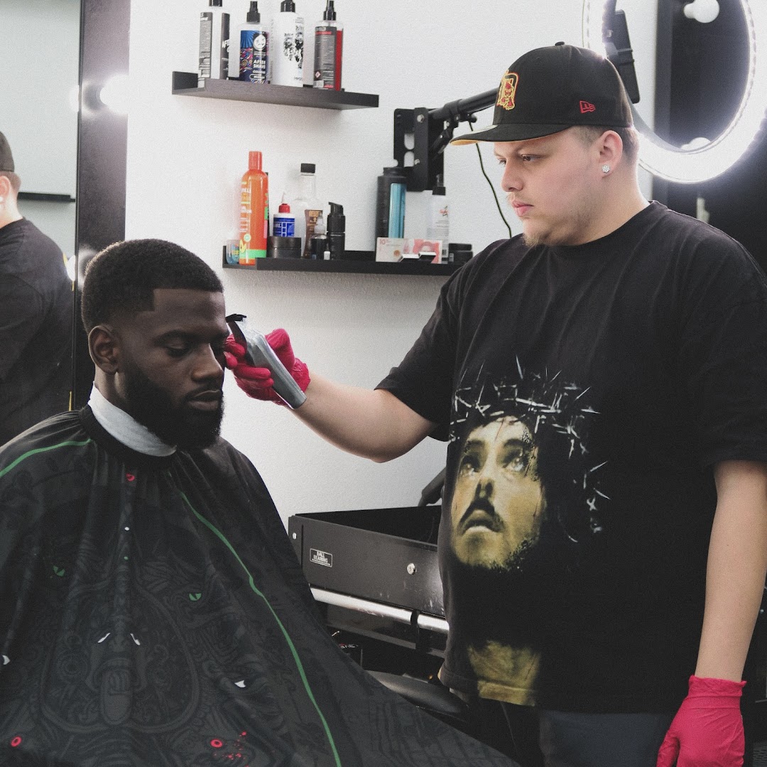 Another Sacrifices barber mid-cut at the chair.