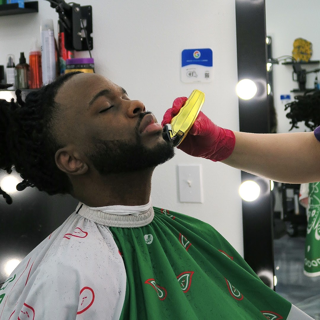 Beard trim close-up with bandana-pattern cape.